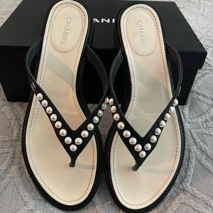 Chanel flip flops with pearl detail.